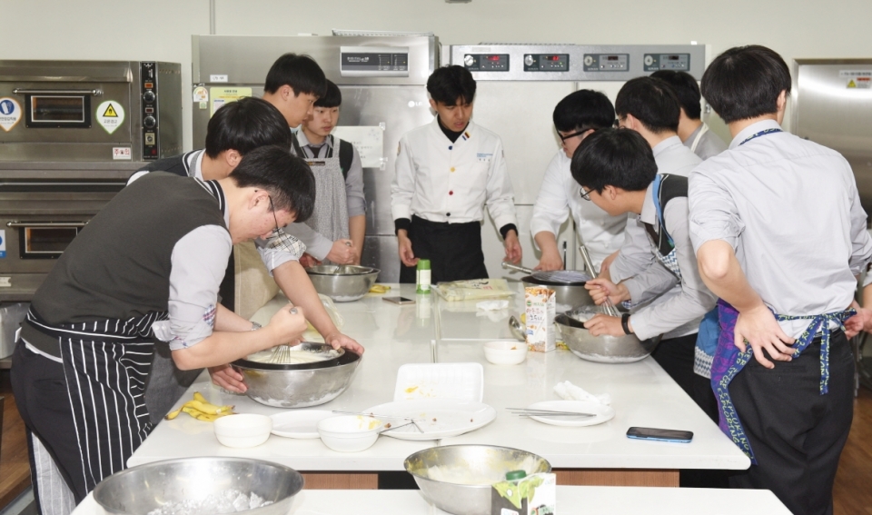 지역 고등학교 학생들에게 요리수업을 지도하고 있는 대구한의대 학생들