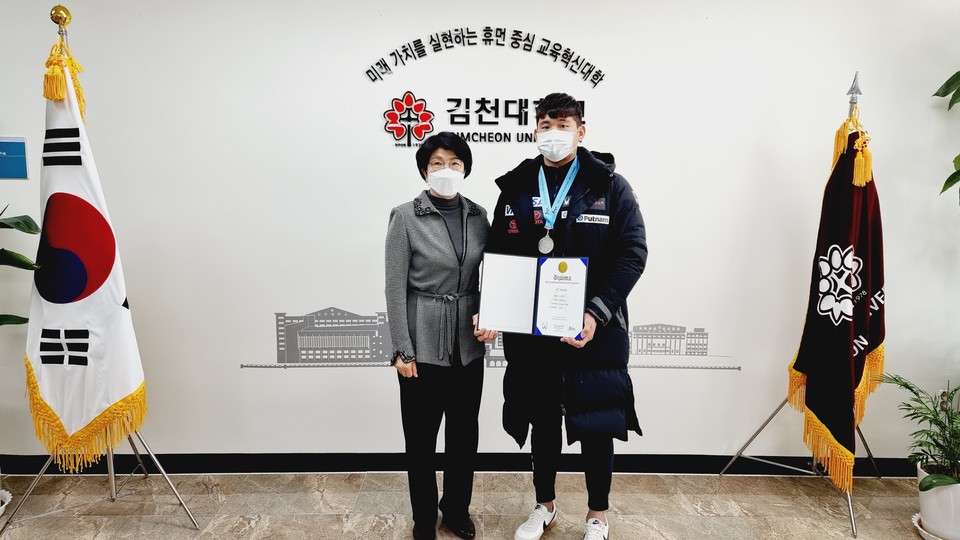 윤옥현 김천대 총장(왼쪽)이 김태영 선수를 격려하고 기념 촬영을 햇다.