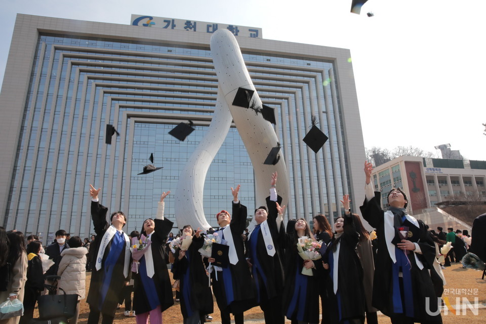 가천대 졸업생들이 23일 대학 상징물 ‘무한대상’ 앞에서 졸업 기념사진을 촬영하고 있다