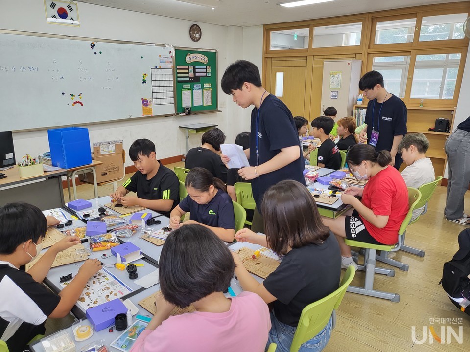 인하랑 학생들이 김포시 서암초등학교 어린이들과 함께 공학 키트 제작활동을 하고 있다.